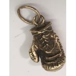 A 9ct gold boxing glove charm..Approx 2cm, 15.6g