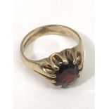 A gent's 9ct gold gypsy ring set with a garnet.App