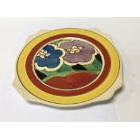 A Clarice Cliff plate decorated with flowers and f