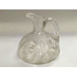 A John Walsh glass jug decorated with leaves, appr
