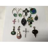 A collection of pendants including silver