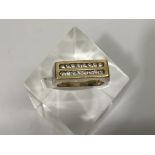 A gent's 9ct gold ring set with sixteen diamonds i