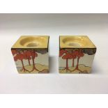 A pair of Clarice Cliff coral firs cube candle sti