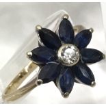 A gold ring with star shaped setting of sapphire a
