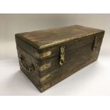 A wooden and brass bound box with carrying handles