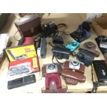 A collection of various cameras and accessories in