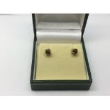 A pair of 9ct gold and spinel ear studs, approx 0.