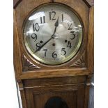A oak cased grand mother clock the circular dial w