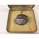 An unusual painted cameo landscape set in a yellow
