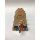 A Clarice Cliff toast rack decorated with the croc