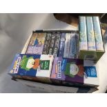 A box of Videos including South Park, Simpson's, S