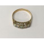 A unmarked gold ring inset with five opals size p