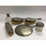 A four piece silver backed dressing table set, a s