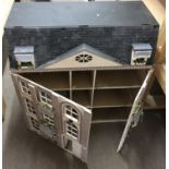 A large wooden doll's house, unfurnished. Approx 9