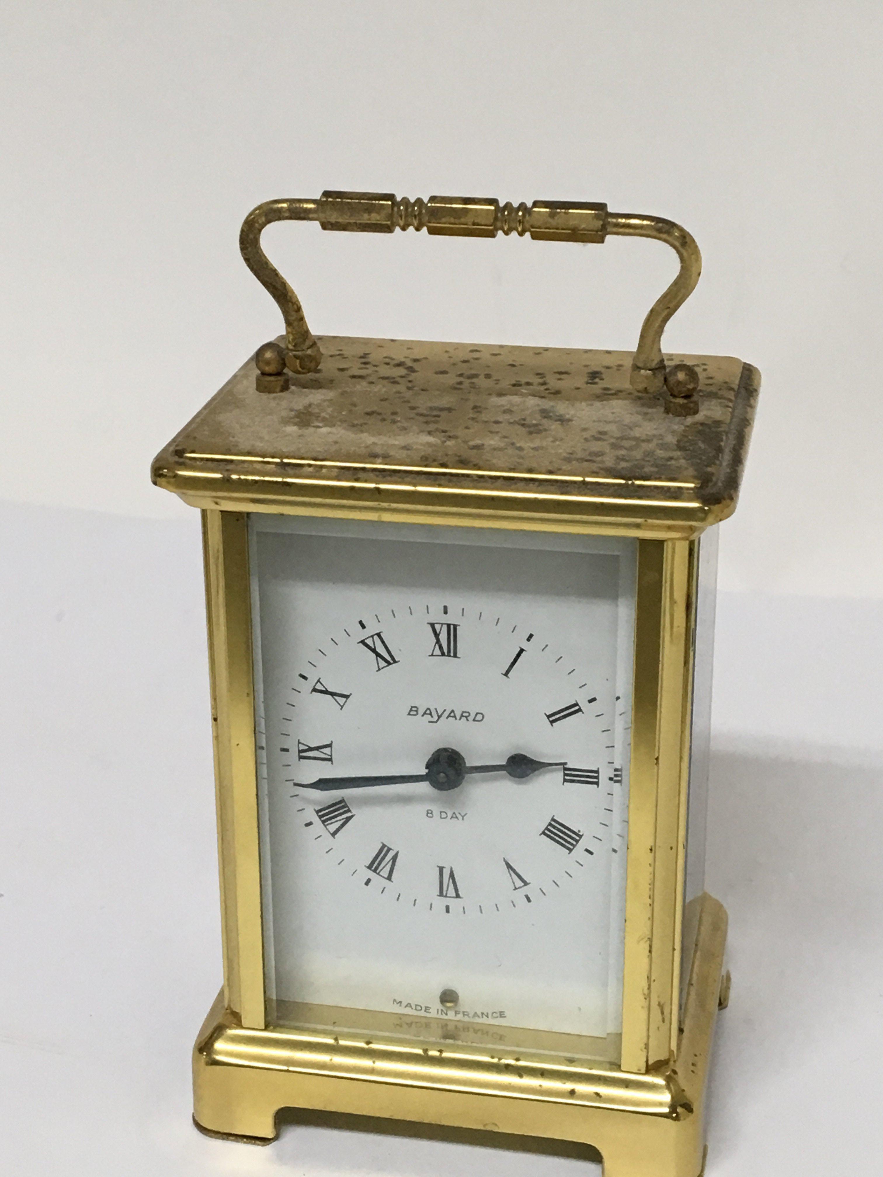 A brass cased French carriage clock the dial and back plate with retailer and makers Duverdrey &