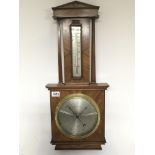 A walnut Android barometer with pillar supports and silvered dial maker Negretti & Zambra. Glass