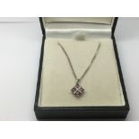 A 9ct white gold pendant set with pink sapphire an