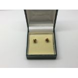 A pair of 9ct gold and cinnamon zircon ear studs,