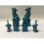 Two pairs of Chinese dogs of fo and similar glazed ducks