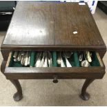 A floorstanding canteen of mixed cutlery