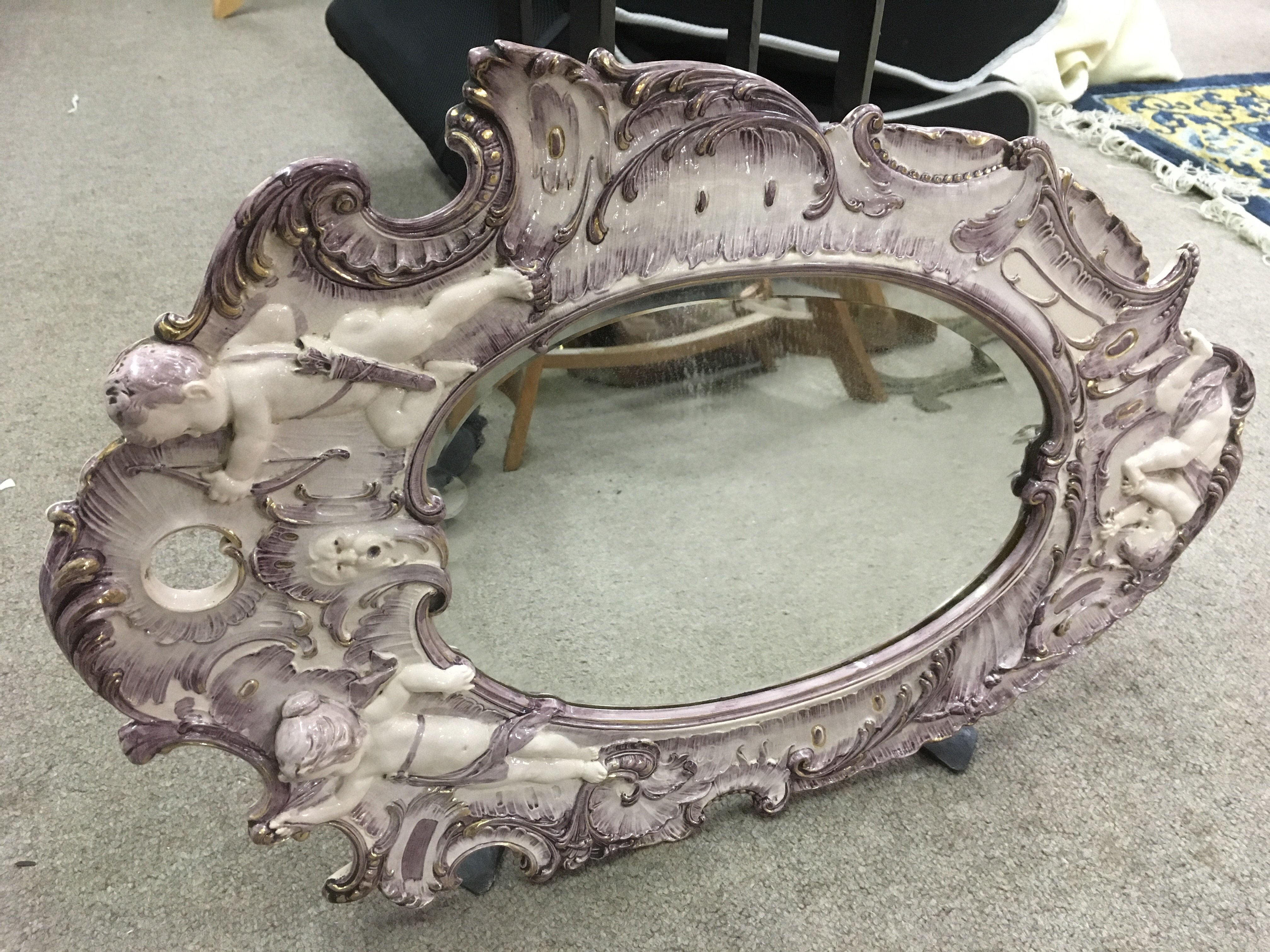 Two Italian style mirrors with swept frames.