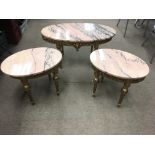 A nest of gilt wood and marble top tables