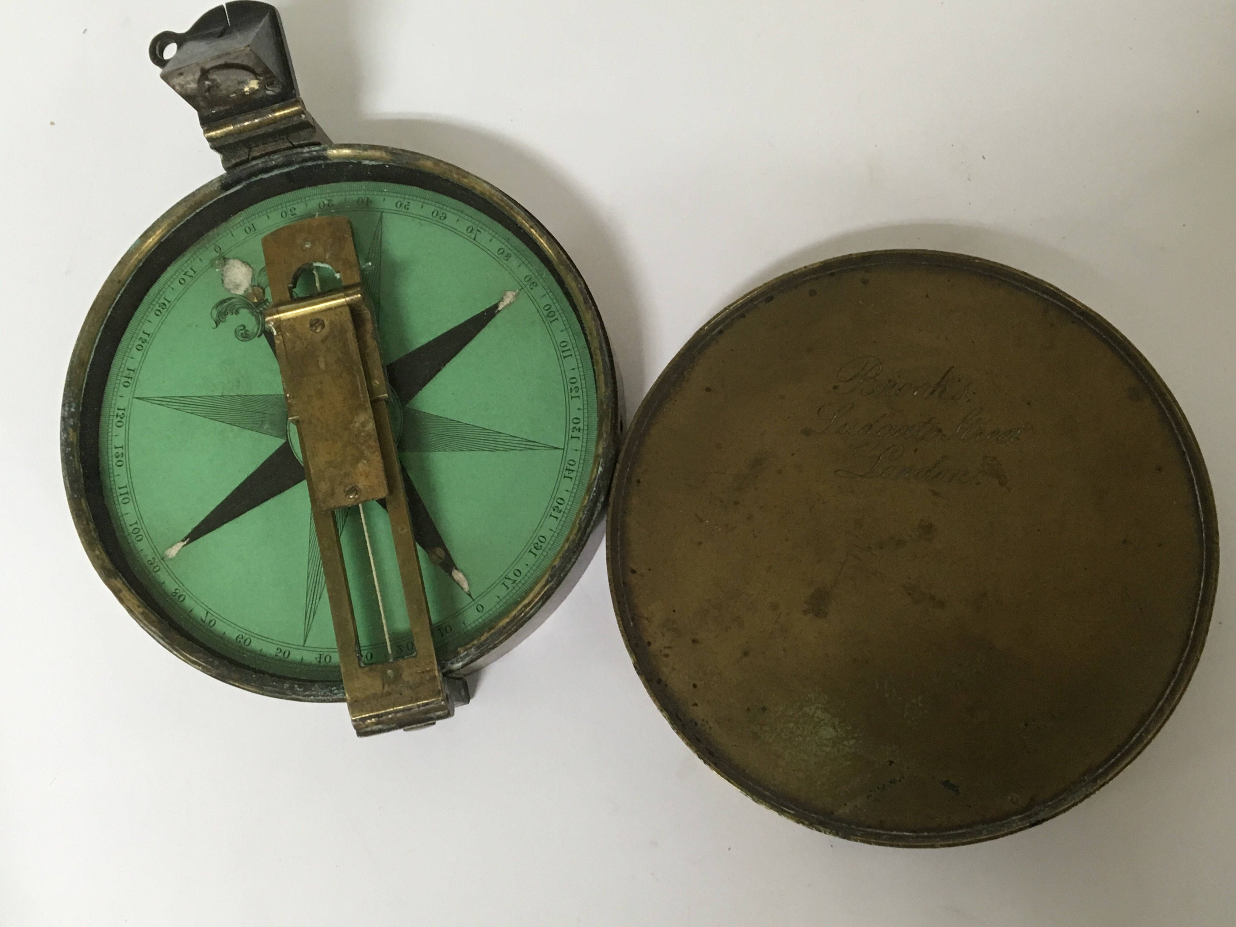 A 19th century oxidised brass cased compass maker