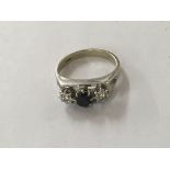 A 18 ct white gold ring inset with central sapphir