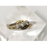 An 18ct gold ring set with a row of three diamonds