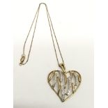 A 9ct gold and diamond set heart shape pendant and