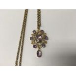 A Edwardian 15 ct gold pendant inset with amethyst