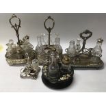 A collection of silver plated cruets inset with gl