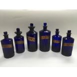 Six Victorian blue glass apothecary bottles, large
