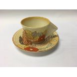 A Clarice Cliff cup saucer decorated in the coral