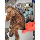 A box containing various plush toys including a la
