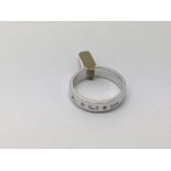 A modern style 18ct white gold diamond set band ri