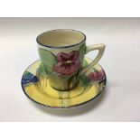 A Clarice Cliff coffee can and saucer decorated wi