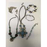 A collection of jewellery including silver charm,