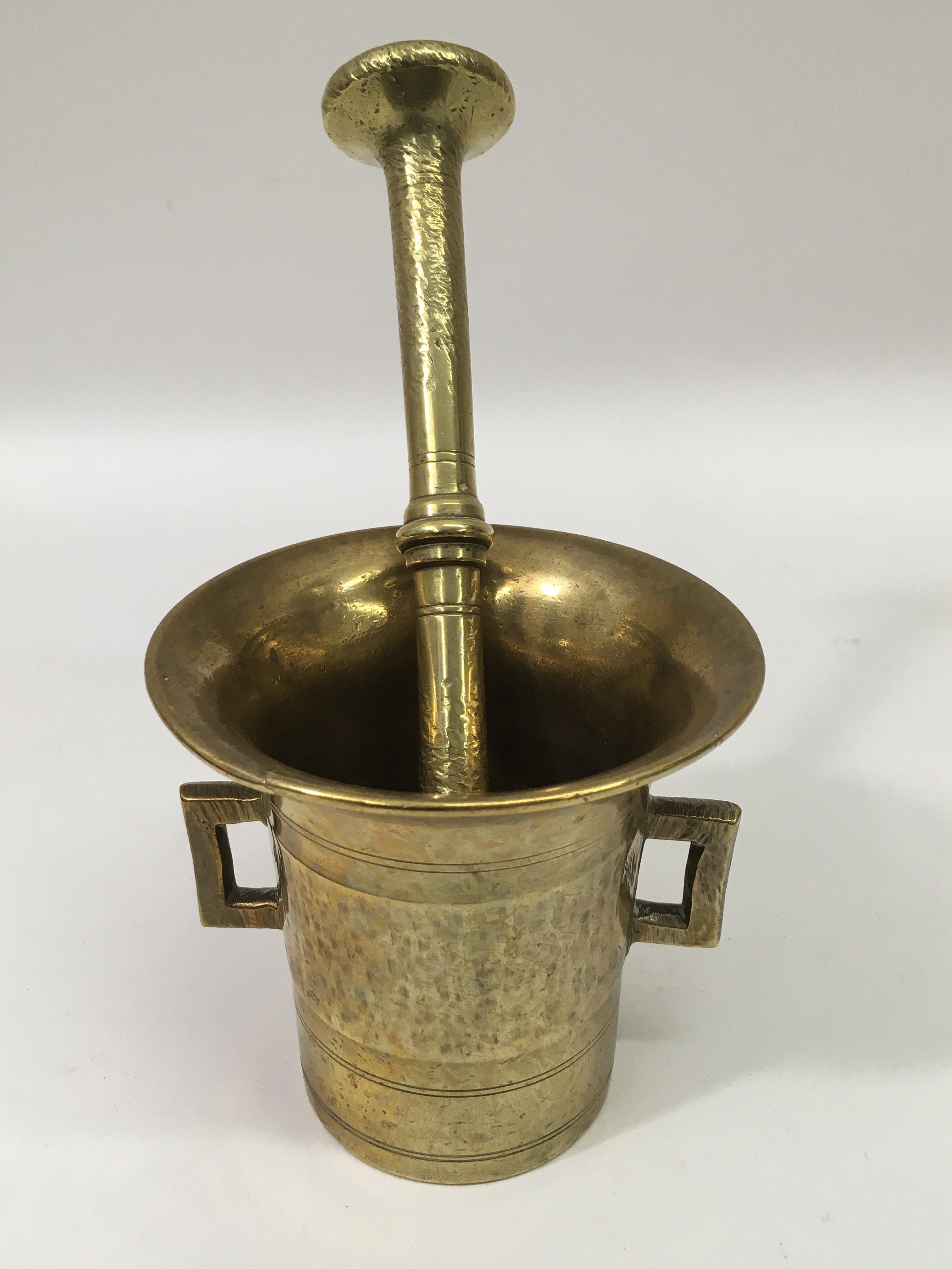 An oriental brass pestle and mortar.Approx 10cm hi