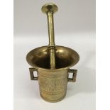 An oriental brass pestle and mortar.Approx 10cm hi