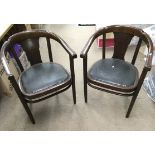 A pair of curved back chairs with leather stud sea
