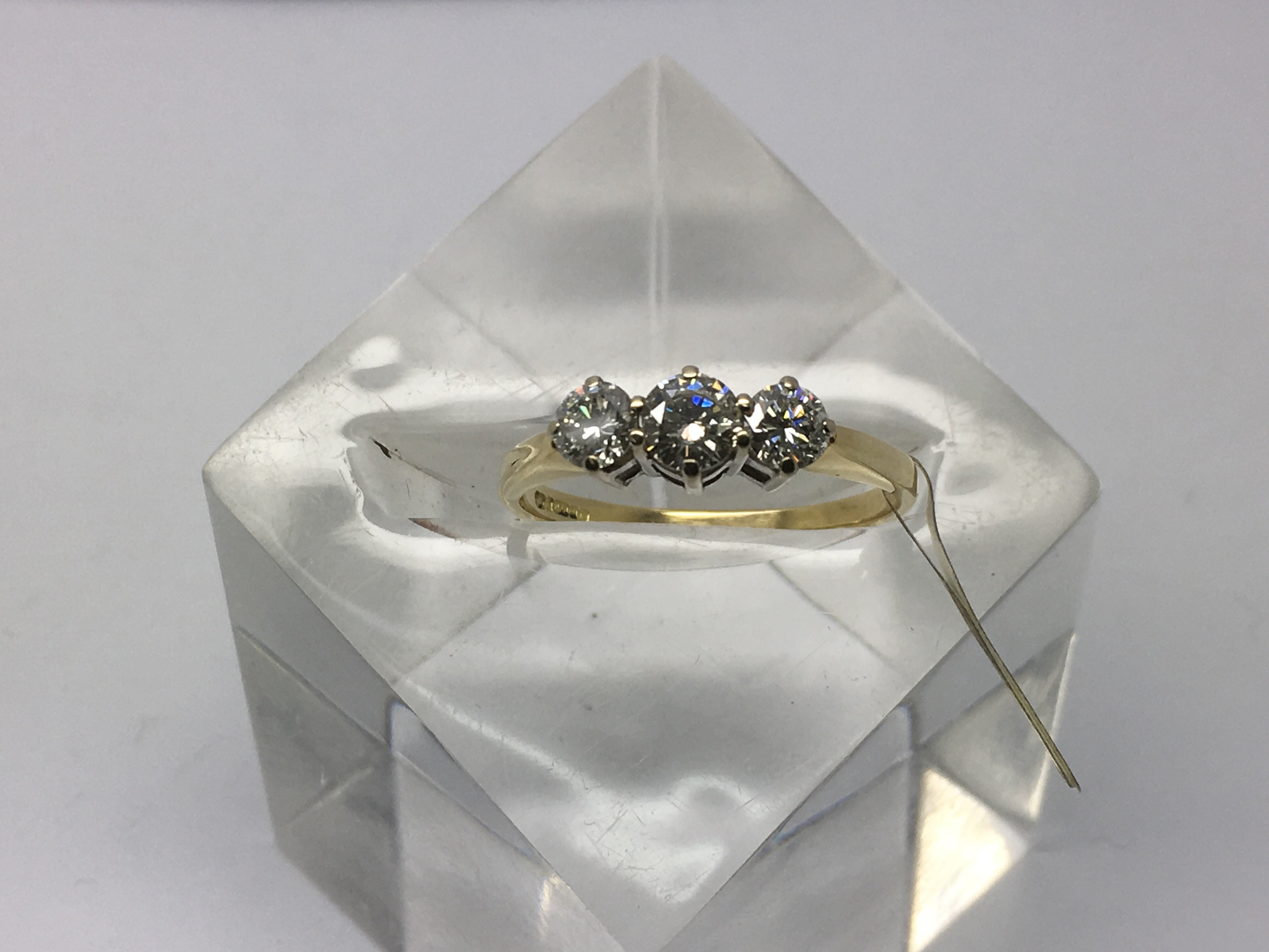 An 18ct gold three stone diamond ring, approx 3/4