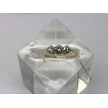 An 18ct gold three stone diamond ring, approx 3/4