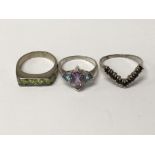 Three decorative silver rings