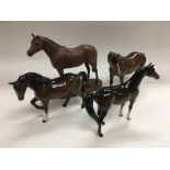 Four Beswick figures of horses.