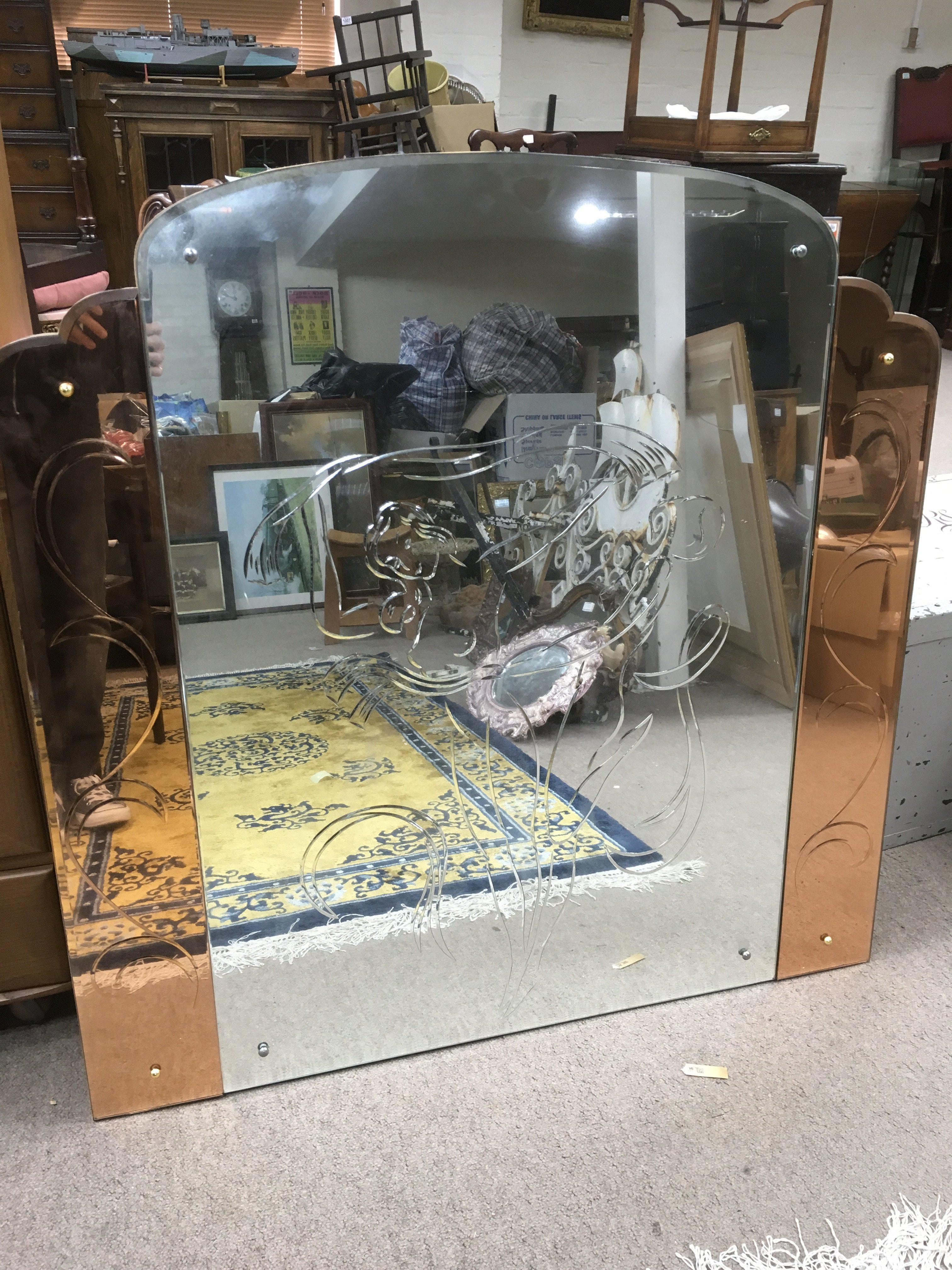 A large Art Deco mirror engraved with nude maidens, approx 107cm x 107cm.