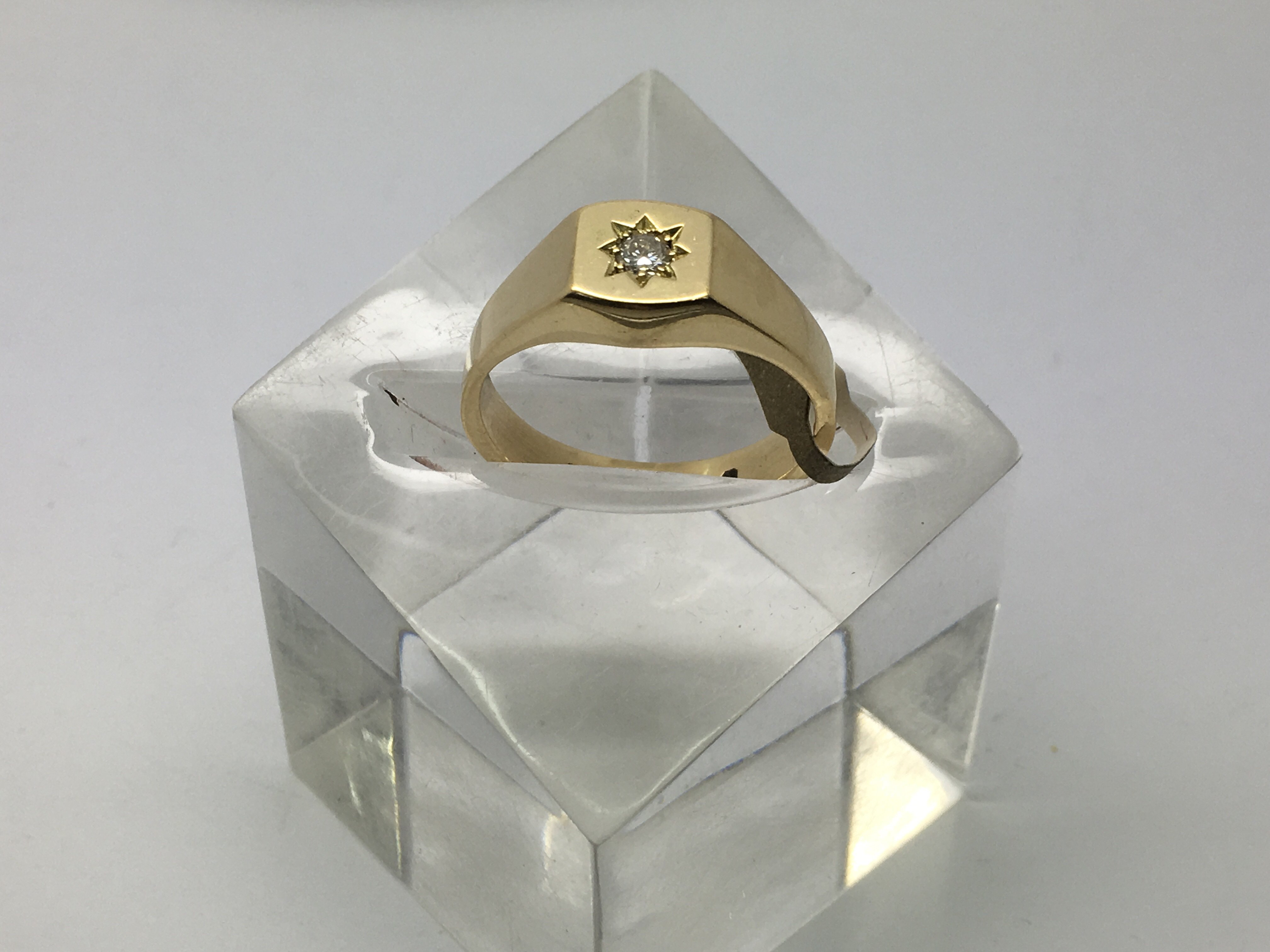 A heavy 18ct gold gents ring set with a diamond, a