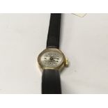 A ladies 9 ct gold wrist watch the dial with Arabic numerals and applied leather strap