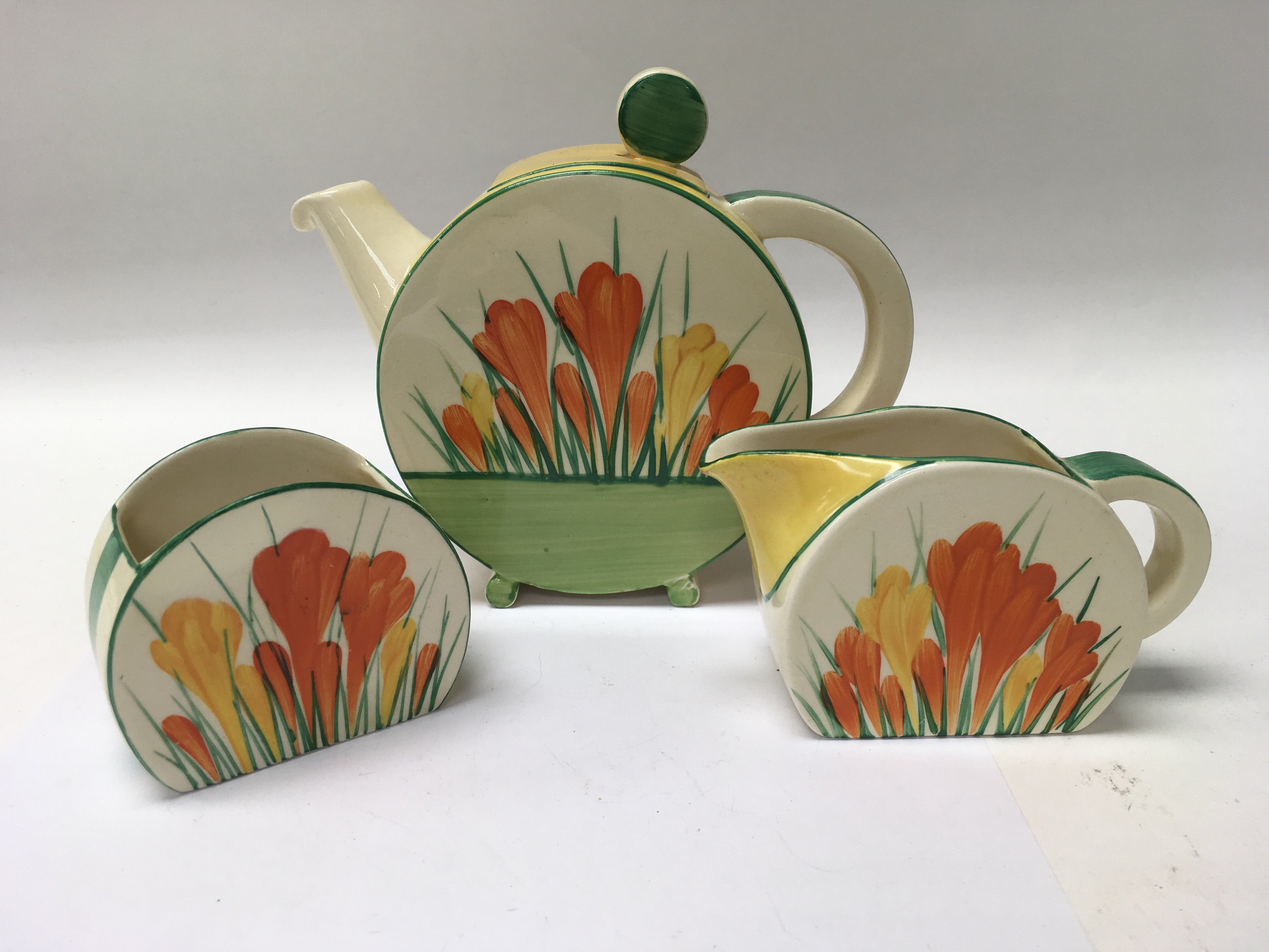 A Clarice Cliff crocus circular tea pot with match