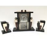 An Art Deco marble and Crome clock garniture with a visible pendulum seen working but fast